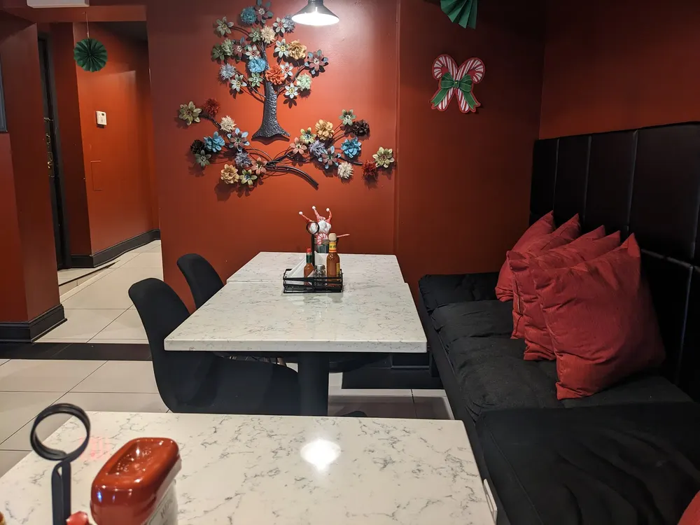 A booth at the diner, with a stone table and colorful wall decorations