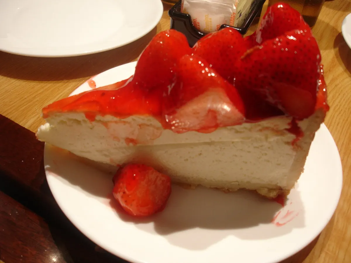 A slice of the diner's strawberry cheesecake topped with fresh strawberries